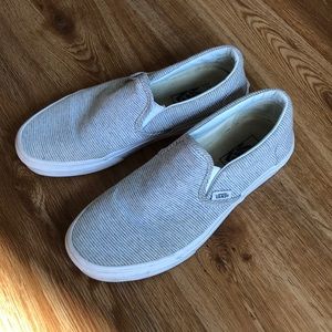 Gray and white striped vans slip on